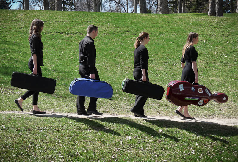 Magic City Strings walking down path in Pioneer Park